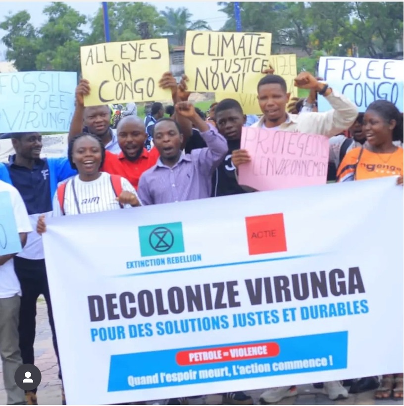 XR Rutshuru Rebels with a sign, "DECOLONIZE VIRUNGA"